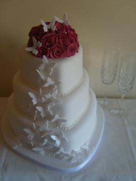 3 tier heart wedding cake with butterflies